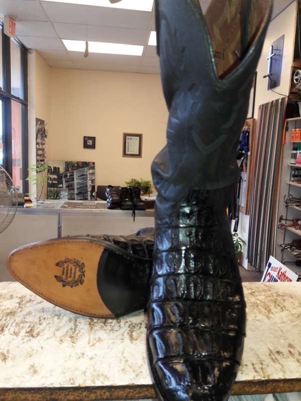 Shined and restored exotic-leather cowboy boot